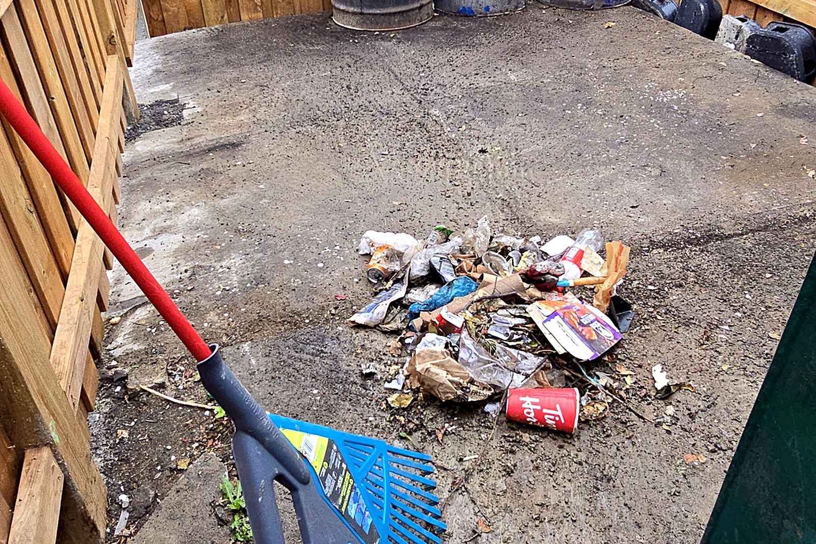 The same enclosure raked out with the litter gathered into one pile