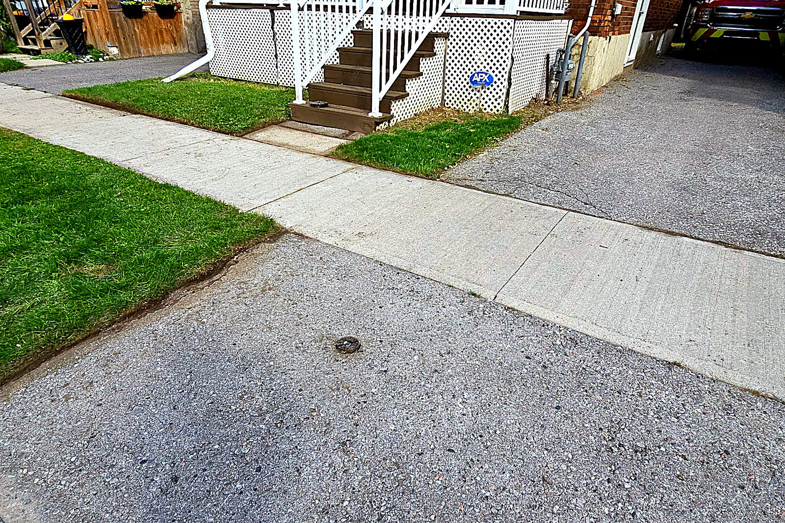 The same driveway apron with the grass edged back off the concrete