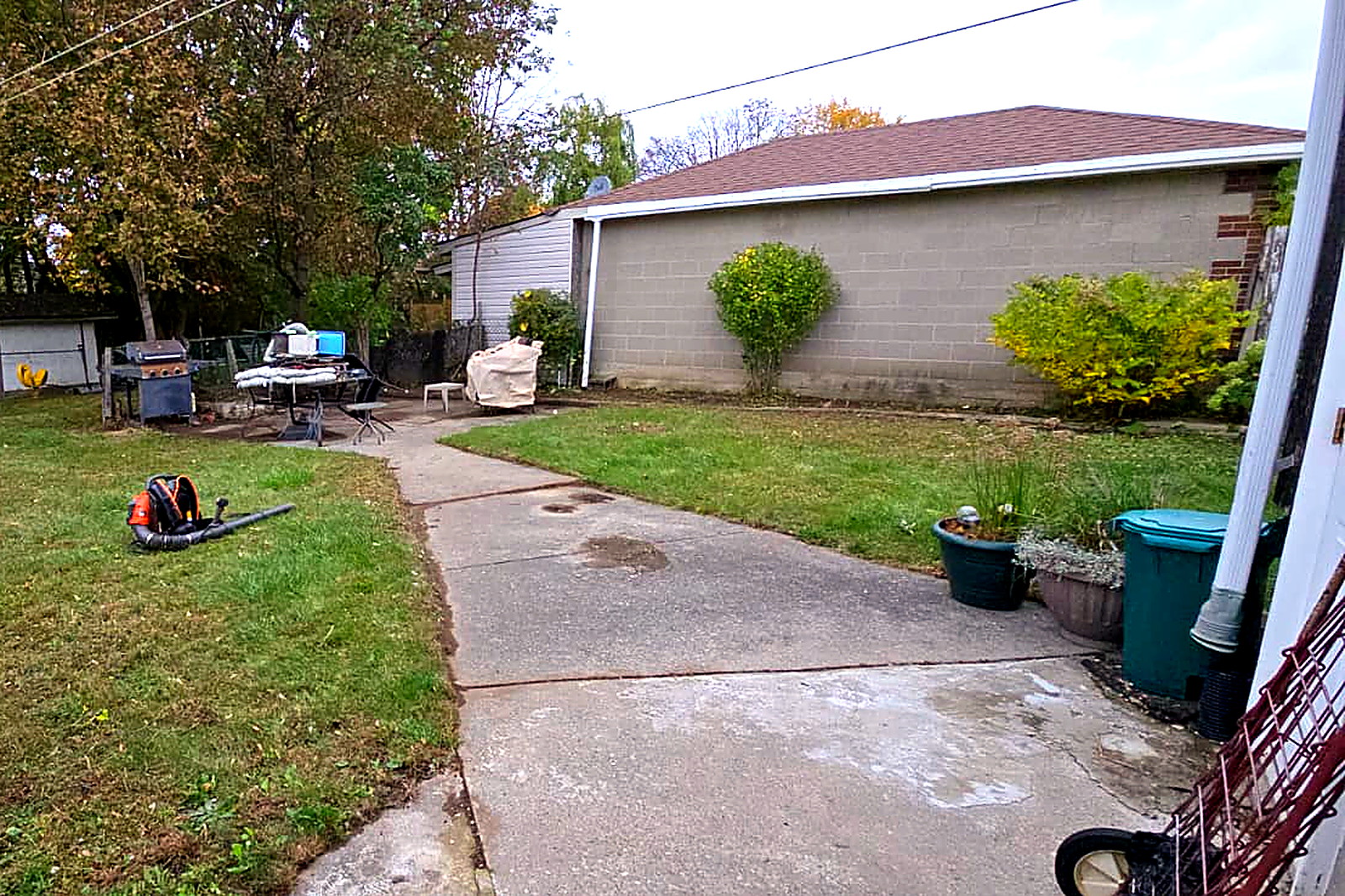 The same garage wall with the border cut right back and the grass clear to the wall